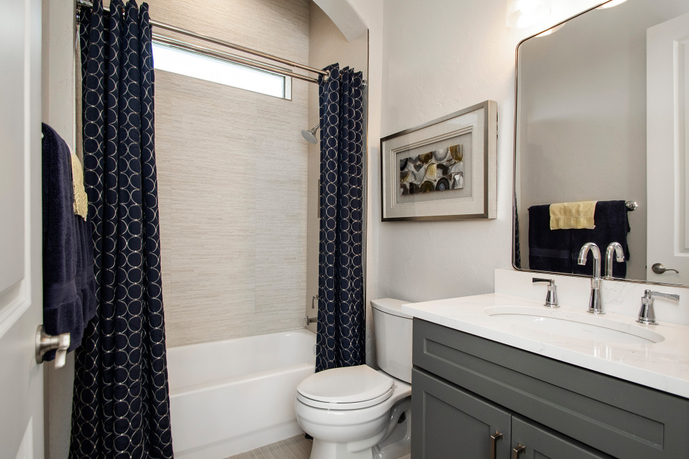 Inspiration for a mid-sized transitional 3/4 gray tile and porcelain tile porcelain tile, gray floor and single-sink bathroom remodel in Dallas with flat-panel cabinets, gray cabinets, a two-piece toilet, gray walls, an undermount sink, quartz countertops, white countertops and a built-in vanity