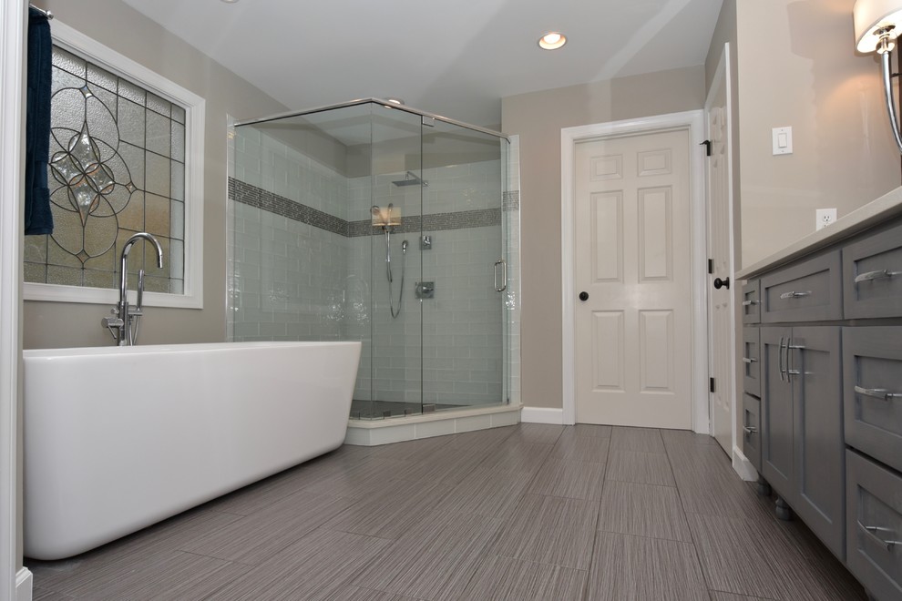 Mid-sized minimalist master gray tile and porcelain tile porcelain tile bathroom photo in Atlanta with shaker cabinets, gray cabinets, a one-piece toilet, gray walls, an undermount sink and quartz countertops