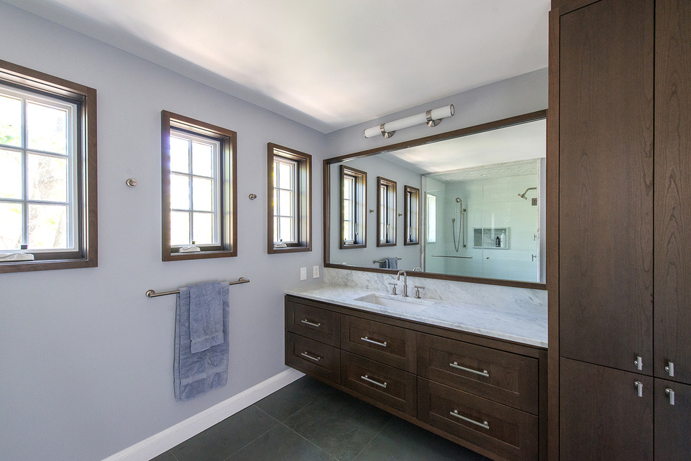 Example of a classic master white tile and marble tile porcelain tile and black floor alcove shower design in DC Metro with shaker cabinets, medium tone wood cabinets, gray walls, an undermount sink, marble countertops and a hinged shower door