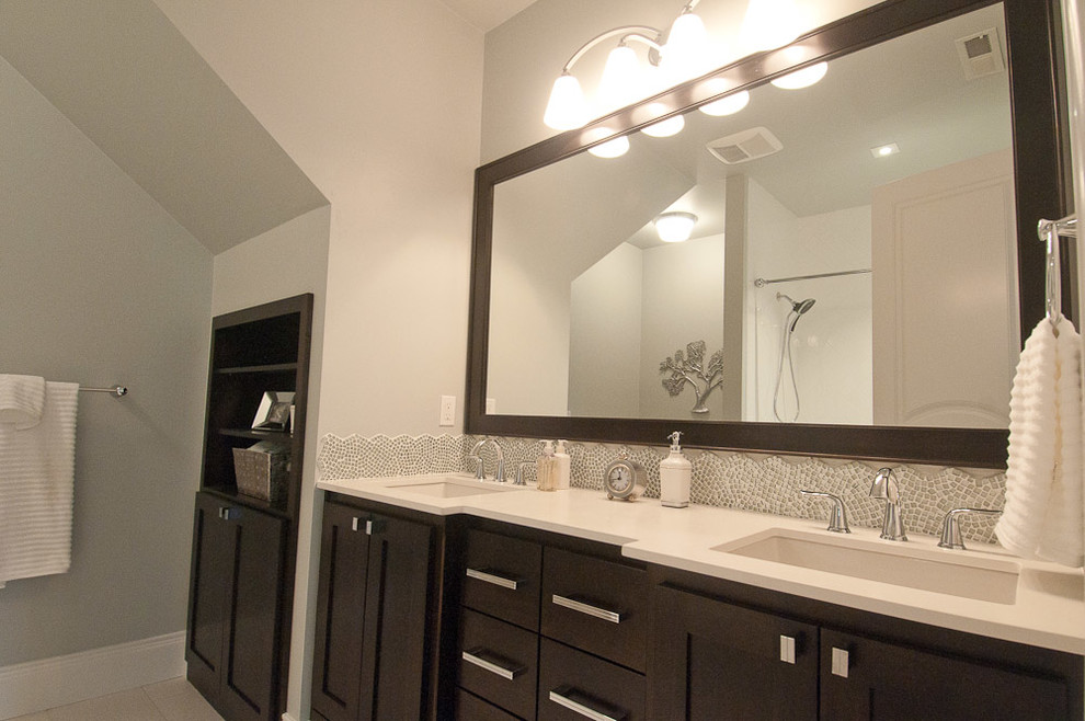 Example of a mid-sized classic kids' gray tile and porcelain tile porcelain tile bathroom design in Portland with furniture-like cabinets, dark wood cabinets, quartzite countertops and gray walls