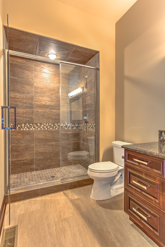Bathroom - large contemporary brown tile and porcelain tile porcelain tile bathroom idea in Omaha with an undermount sink, recessed-panel cabinets, medium tone wood cabinets, quartz countertops, a one-piece toilet and beige walls