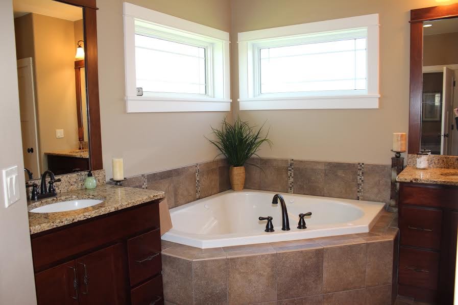 Inspiration for a large timeless master beige tile, brown tile and ceramic tile ceramic tile bathroom remodel in Cedar Rapids with flat-panel cabinets, dark wood cabinets, a two-piece toilet, brown walls, an undermount sink and granite countertops