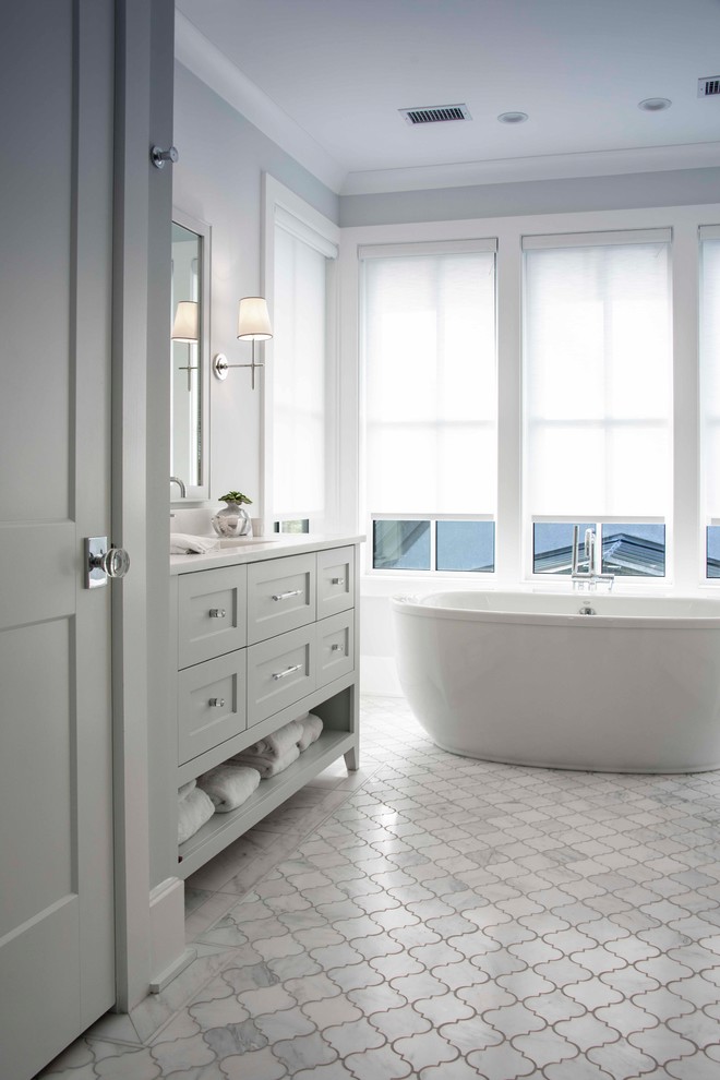 Пример оригинального дизайна: ванная комната в стиле неоклассика (современная классика) с фасадами в стиле шейкер, белыми фасадами, отдельно стоящей ванной, белыми стенами, душевой кабиной, врезной раковиной, белым полом и белой столешницей