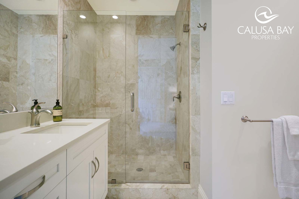 Example of an island style kids' bathroom design in Miami with an integrated sink