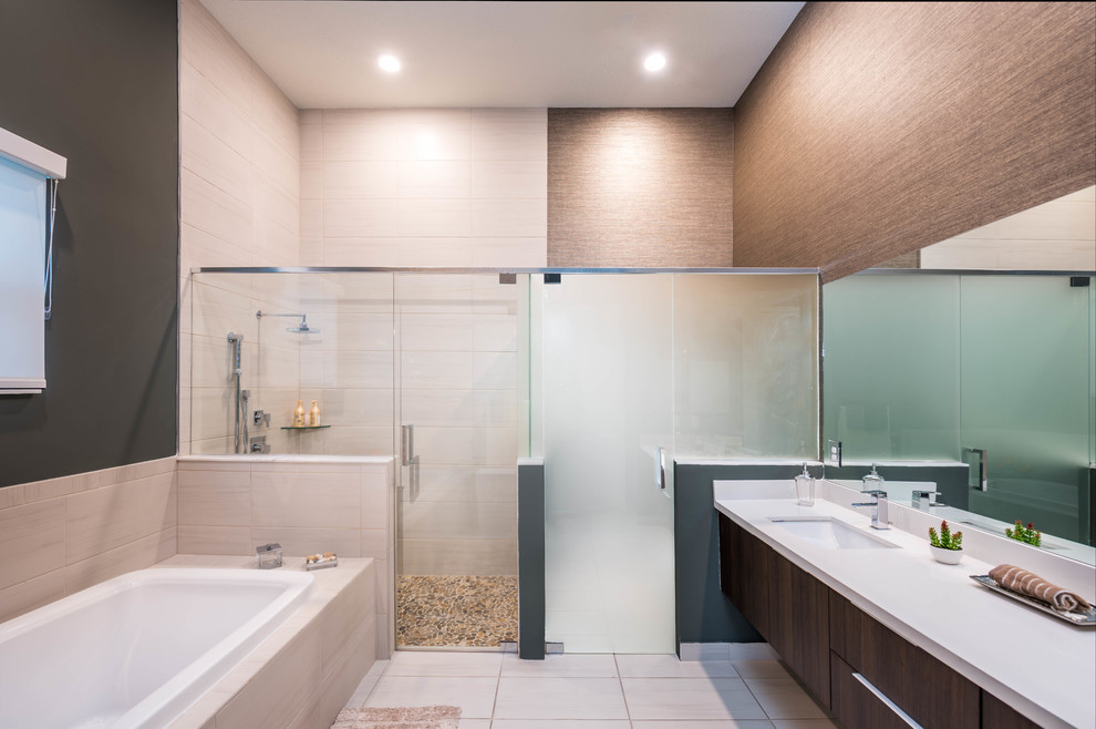 Photo of a large traditional ensuite bathroom in Miami with flat-panel cabinets, dark wood cabinets, a shower/bath combination, beige tiles, multi-coloured walls, a built-in sink, soapstone worktops and a hinged door.