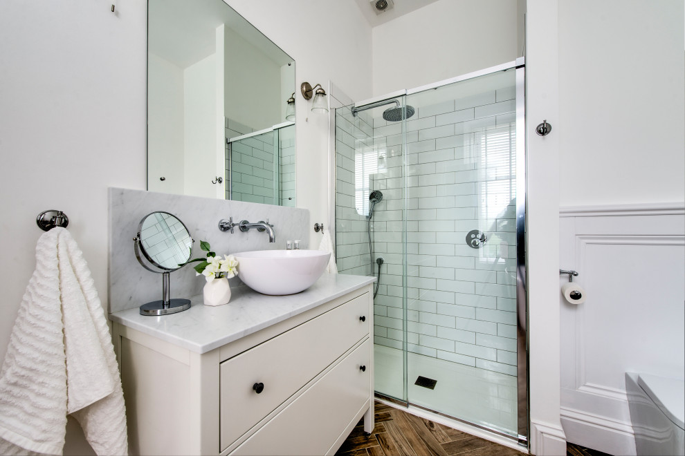 Inspiration for a traditional shower room bathroom in Glasgow with beige cabinets, an alcove shower, a wall mounted toilet, white tiles, metro tiles, white walls, a vessel sink, brown floors, a sliding door, grey worktops and flat-panel cabinets.