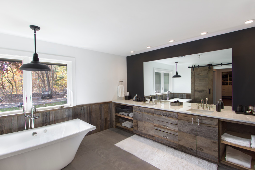 Идея дизайна: большая главная ванная комната в современном стиле с врезной раковиной, фасадами цвета дерева среднего тона, отдельно стоящей ванной, серой плиткой и белыми стенами