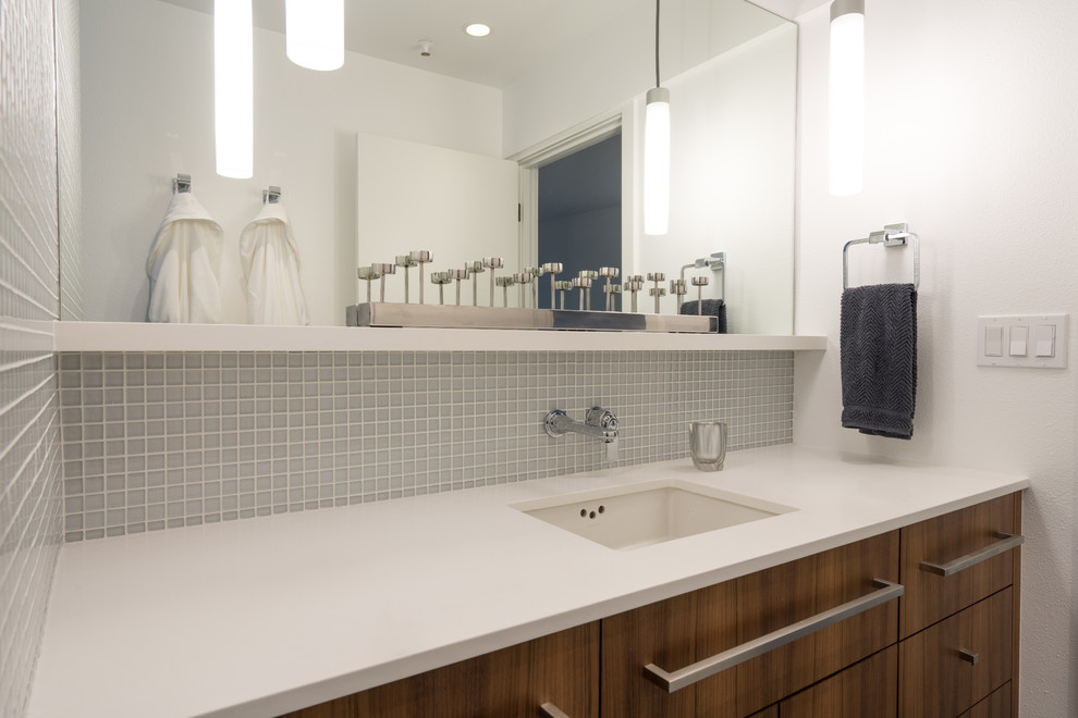Example of a small minimalist glass tile light wood floor bathroom design in Seattle with flat-panel cabinets, medium tone wood cabinets, a one-piece toilet, white walls, quartzite countertops and white countertops