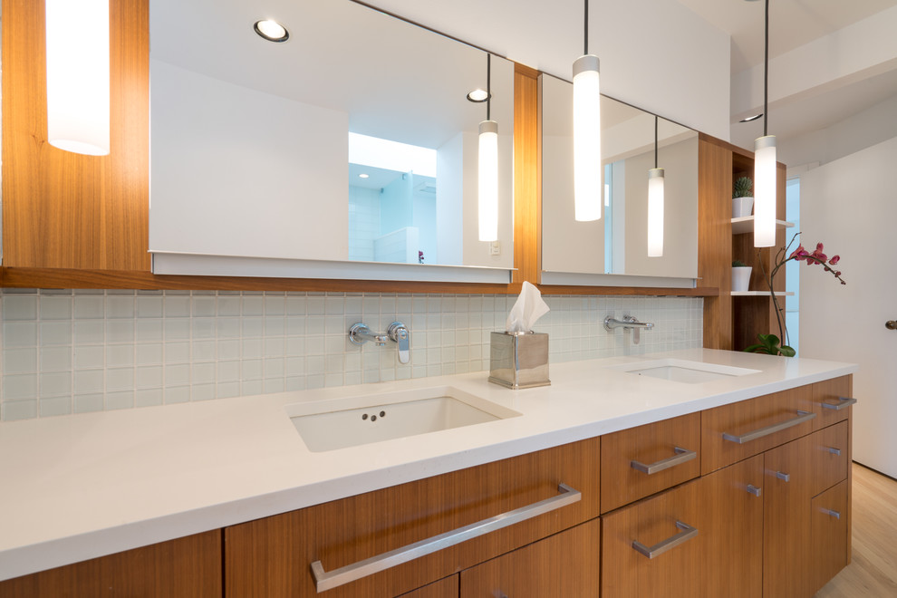 Example of a minimalist master white tile and glass tile porcelain tile and gray floor bathroom design in Seattle with flat-panel cabinets, medium tone wood cabinets, a one-piece toilet, white walls, an undermount sink, quartzite countertops and white countertops