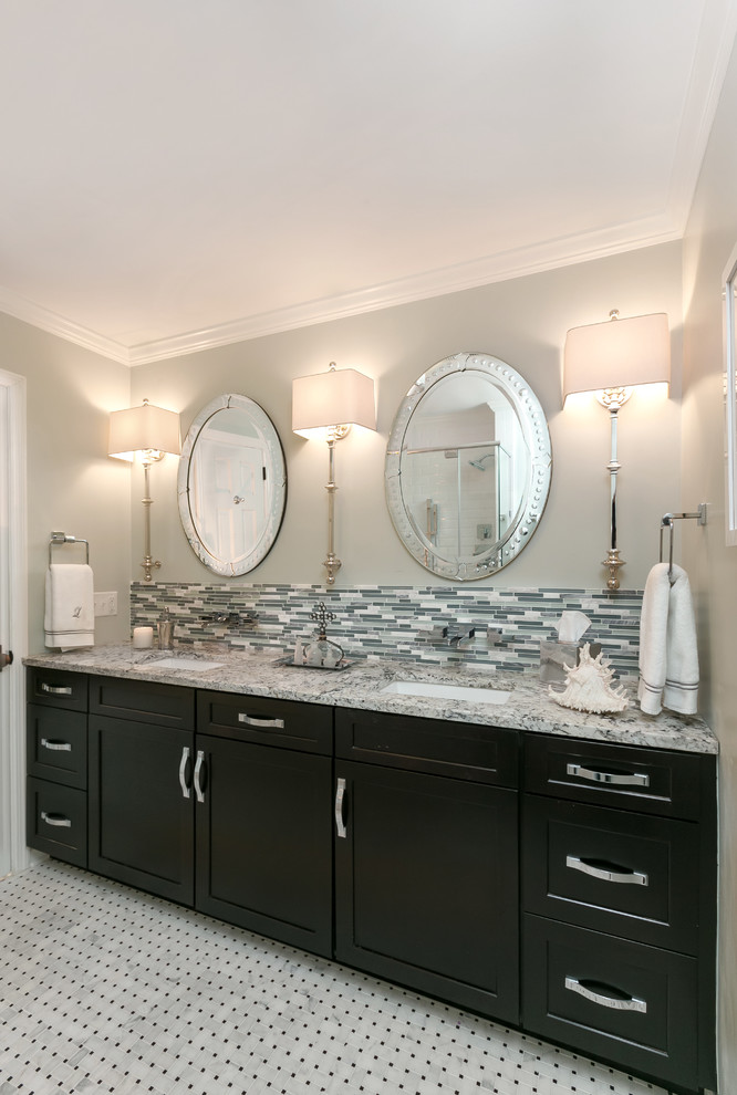 Mid-sized elegant gray tile and matchstick tile ceramic tile bathroom photo in Charleston with a drop-in sink, recessed-panel cabinets, black cabinets, granite countertops and gray walls