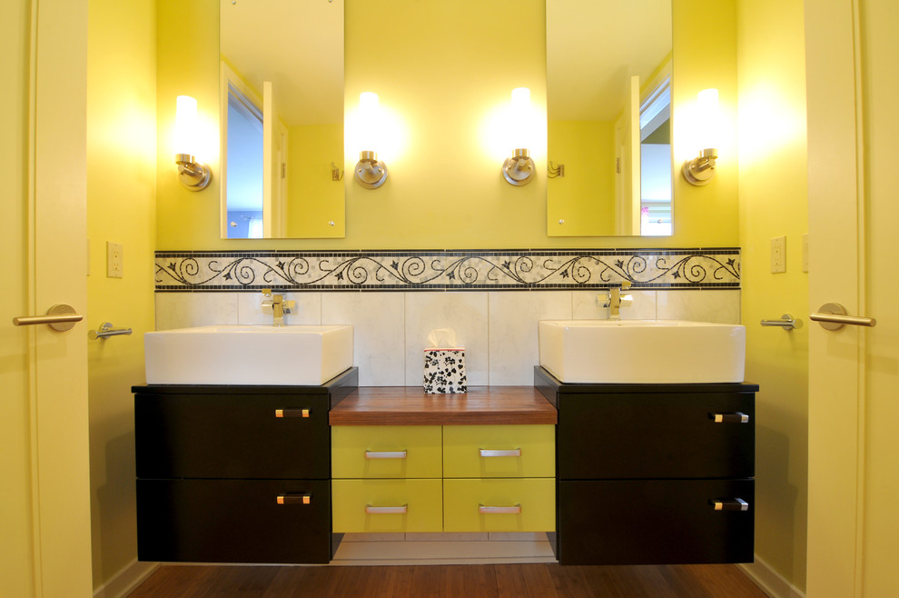 Example of a classic white tile and ceramic tile bathroom design in New York with a vessel sink, flat-panel cabinets, black cabinets and wood countertops