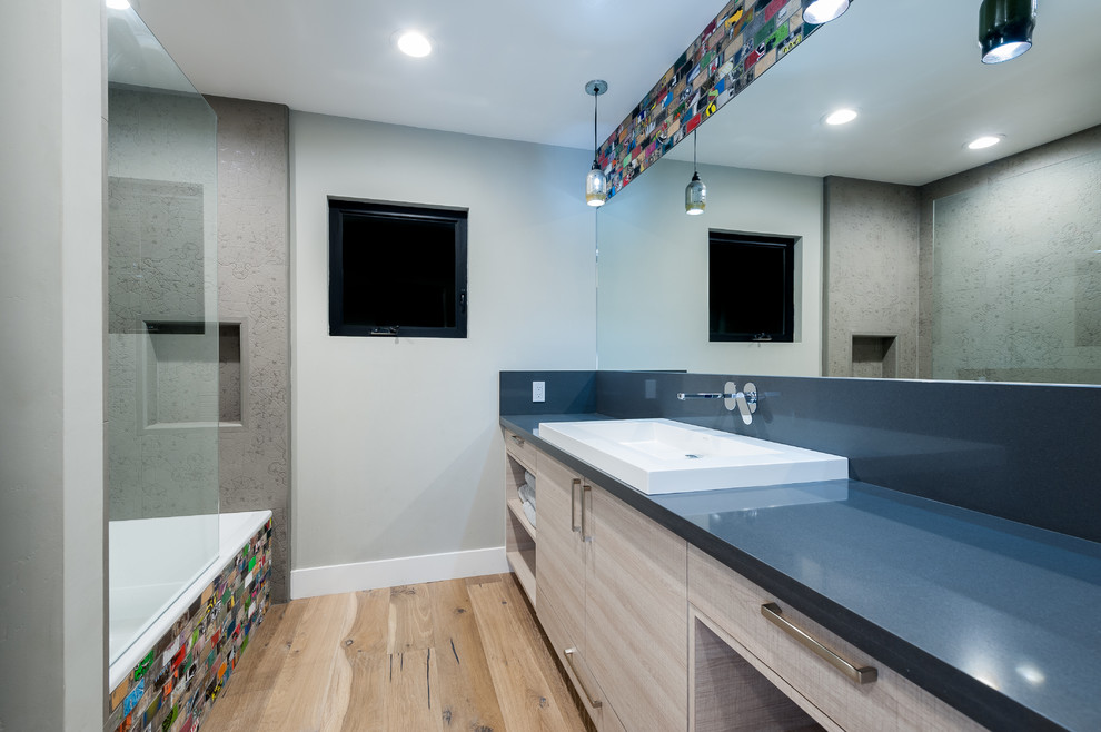 Inspiration for a large modern kids' multicolored tile and mosaic tile medium tone wood floor and brown floor bathroom remodel in San Diego with a trough sink, flat-panel cabinets, light wood cabinets, quartz countertops, a one-piece toilet and gray walls