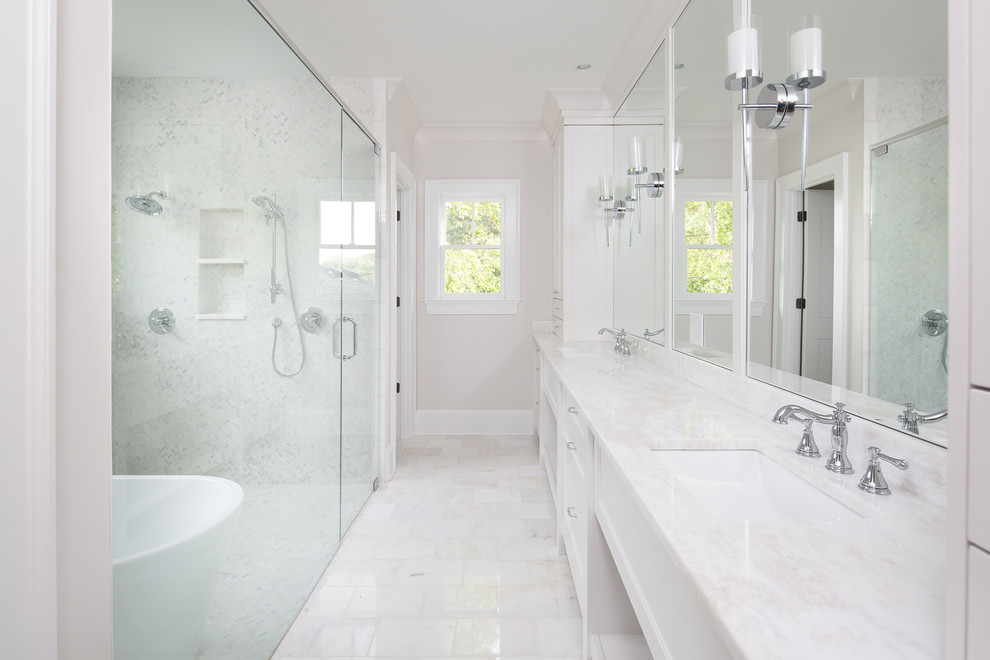 Example of a large transitional master white tile white floor and marble floor bathroom design in Atlanta with white cabinets, white walls, an undermount sink, a hinged shower door, recessed-panel cabinets and quartz countertops