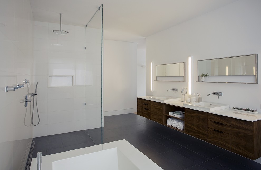 Design ideas for a large modern ensuite bathroom in Boston with flat-panel cabinets, dark wood cabinets, a freestanding bath, a walk-in shower, white tiles, ceramic tiles, white walls, medium hardwood flooring, a built-in sink, engineered stone worktops, beige floors, an open shower and white worktops.