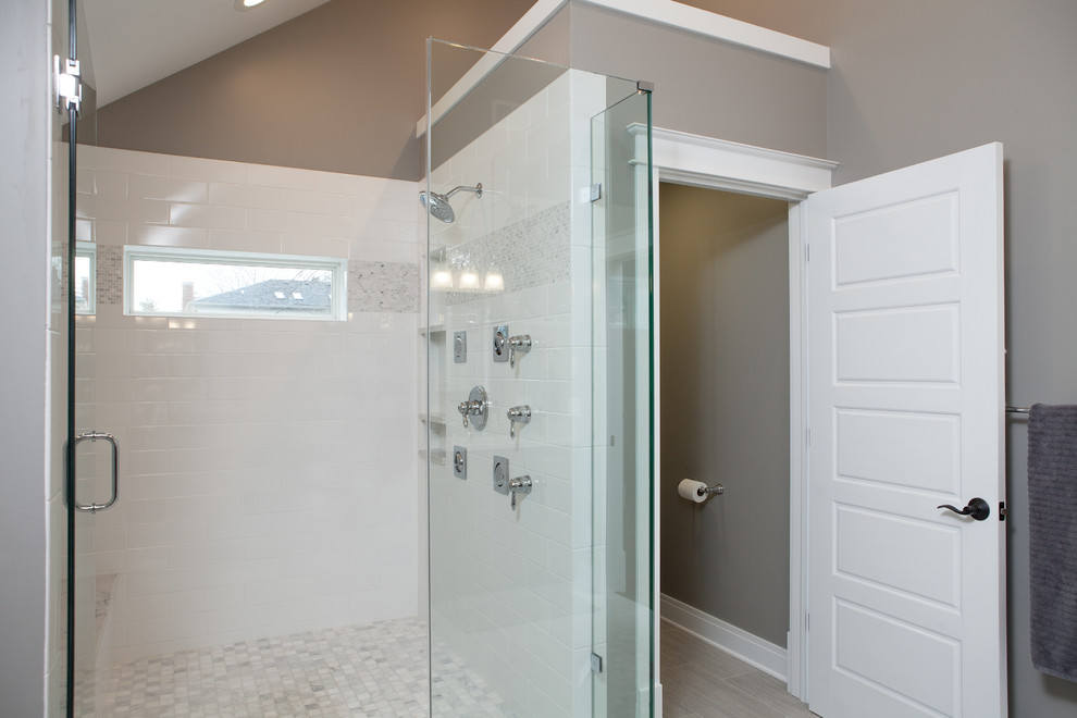 Doorless shower - large traditional master white tile and subway tile medium tone wood floor doorless shower idea in Chicago with shaker cabinets, dark wood cabinets, a one-piece toilet, gray walls, an undermount sink and quartz countertops