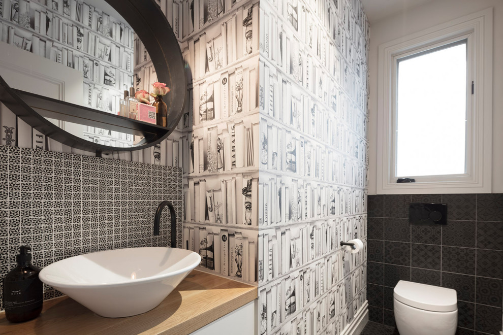 Foto di una stanza da bagno contemporanea con ante lisce, ante bianche, piastrelle nere, pareti bianche, lavabo a bacinella, top in legno, pavimento nero e top beige