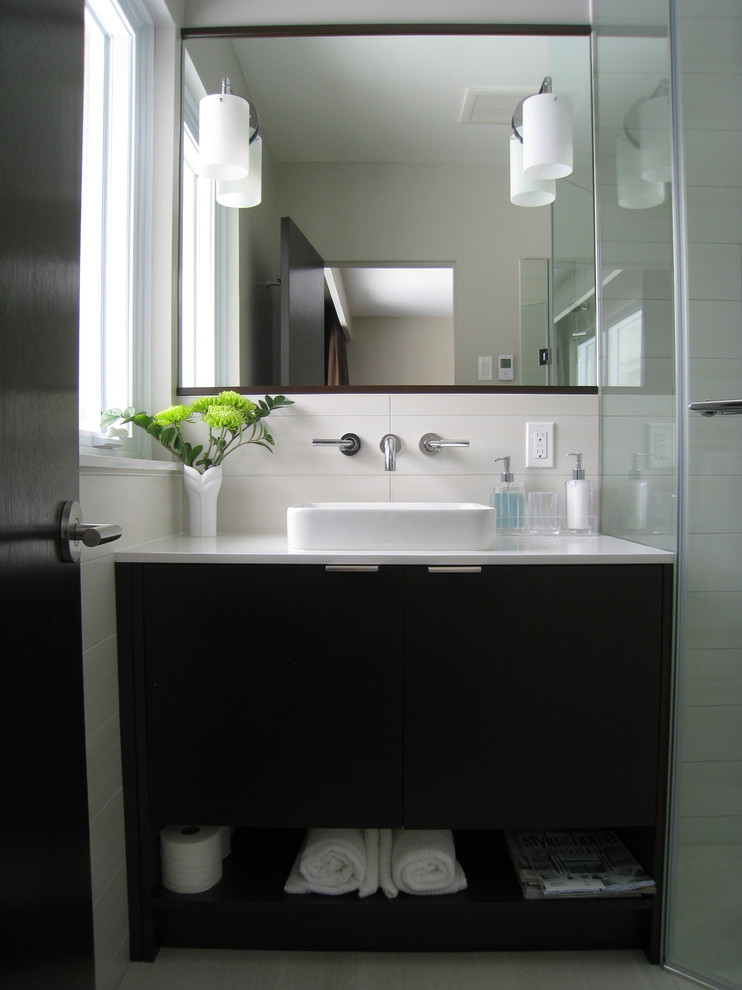 This is an example of a small contemporary shower room bathroom in Toronto with a built-in sink, flat-panel cabinets, dark wood cabinets, engineered stone worktops, a corner shower, a one-piece toilet, grey tiles, porcelain tiles, grey walls and porcelain flooring.
