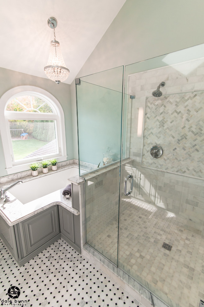 Inspiration for a medium sized traditional ensuite bathroom in Boston with raised-panel cabinets, blue cabinets, a submerged bath, a double shower, a two-piece toilet, black and white tiles, stone tiles, blue walls, marble flooring, a submerged sink and engineered stone worktops.