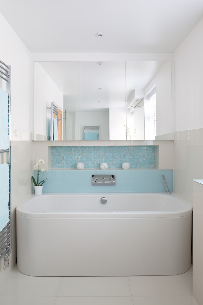 Photo of a contemporary bathroom in Other with blue tiles and a wall niche.