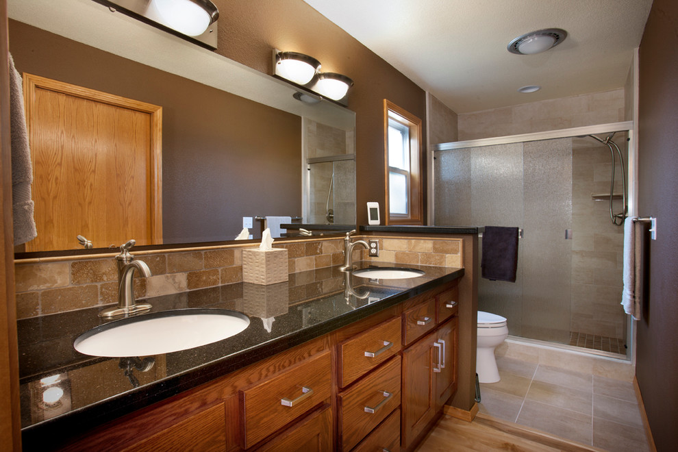 Bathroom - mid-sized contemporary master beige tile and stone tile light wood floor bathroom idea in Boise with an undermount sink, shaker cabinets, medium tone wood cabinets, granite countertops, a two-piece toilet and brown walls
