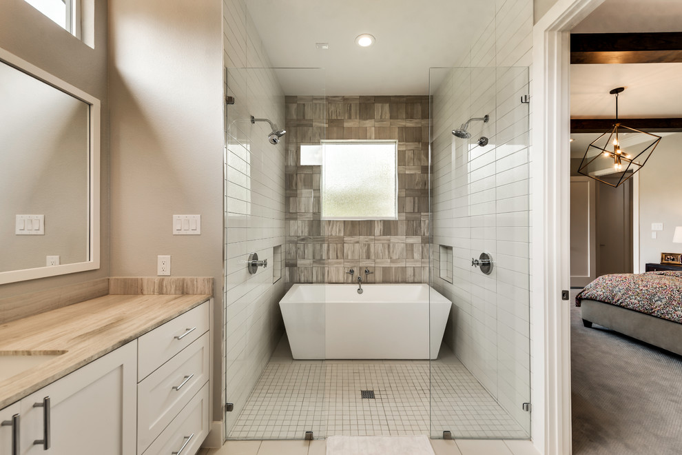 Inspiration for a traditional ensuite bathroom in Dallas with shaker cabinets, a freestanding bath, a double shower, beige tiles, limestone tiles, beige walls, porcelain flooring, a submerged sink, limestone worktops, beige floors and an open shower.