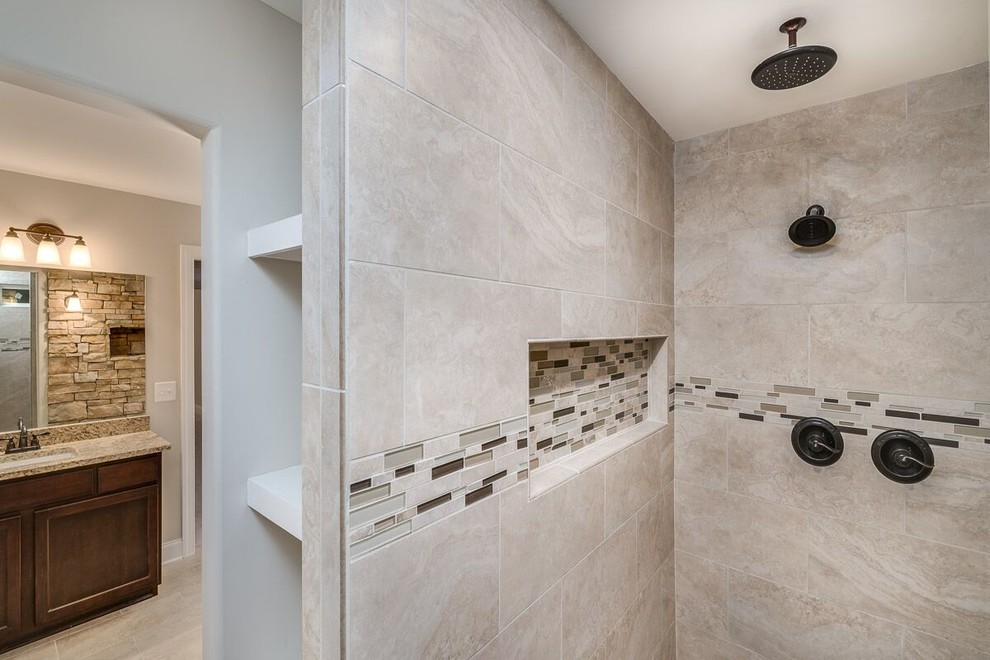 This is an example of a medium sized classic shower room bathroom in Atlanta with recessed-panel cabinets, dark wood cabinets, a freestanding bath, a walk-in shower, beige tiles, stone tiles, beige walls, ceramic flooring, a submerged sink, granite worktops, beige floors and an open shower.