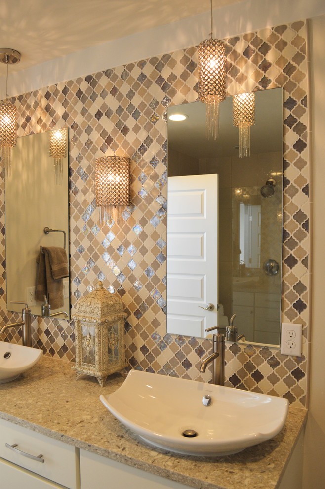 This is an example of a large mediterranean ensuite bathroom in Salt Lake City with shaker cabinets, beige cabinets, an alcove shower, a two-piece toilet, multi-coloured tiles, mosaic tiles, beige walls, porcelain flooring, a vessel sink and engineered stone worktops.
