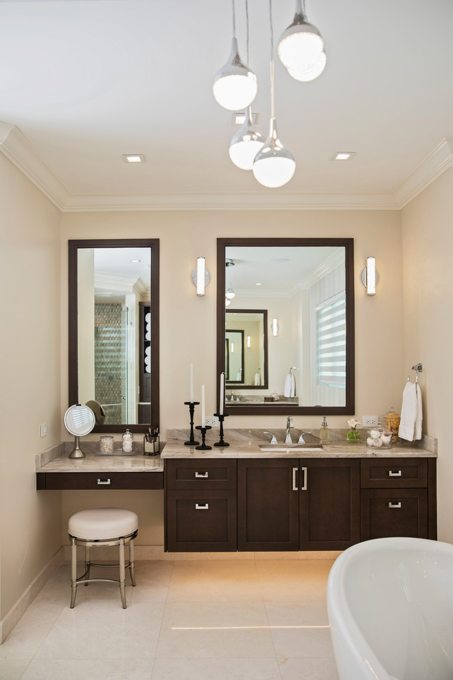 Diseño de cuarto de baño principal tradicional renovado con armarios estilo shaker, puertas de armario de madera en tonos medios, paredes beige, lavabo bajoencimera, suelo beige, encimeras beige y espejo con luz