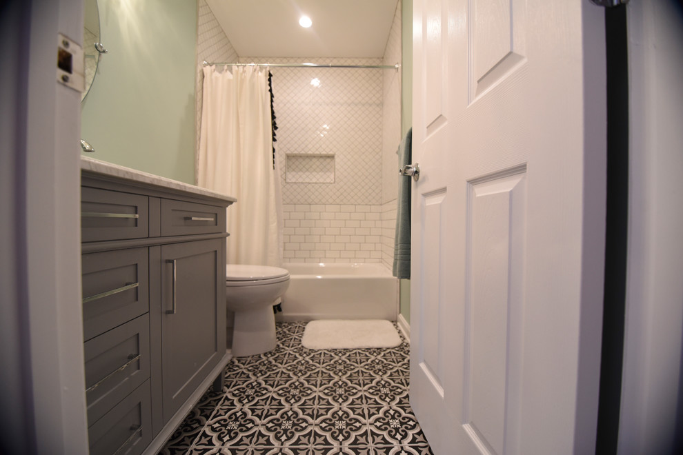 Medium sized traditional family bathroom in Baltimore with shaker cabinets, grey cabinets, a built-in bath, an alcove shower, a two-piece toilet, white tiles, ceramic tiles, ceramic flooring, a submerged sink, engineered stone worktops, black floors, a hinged door and green walls.