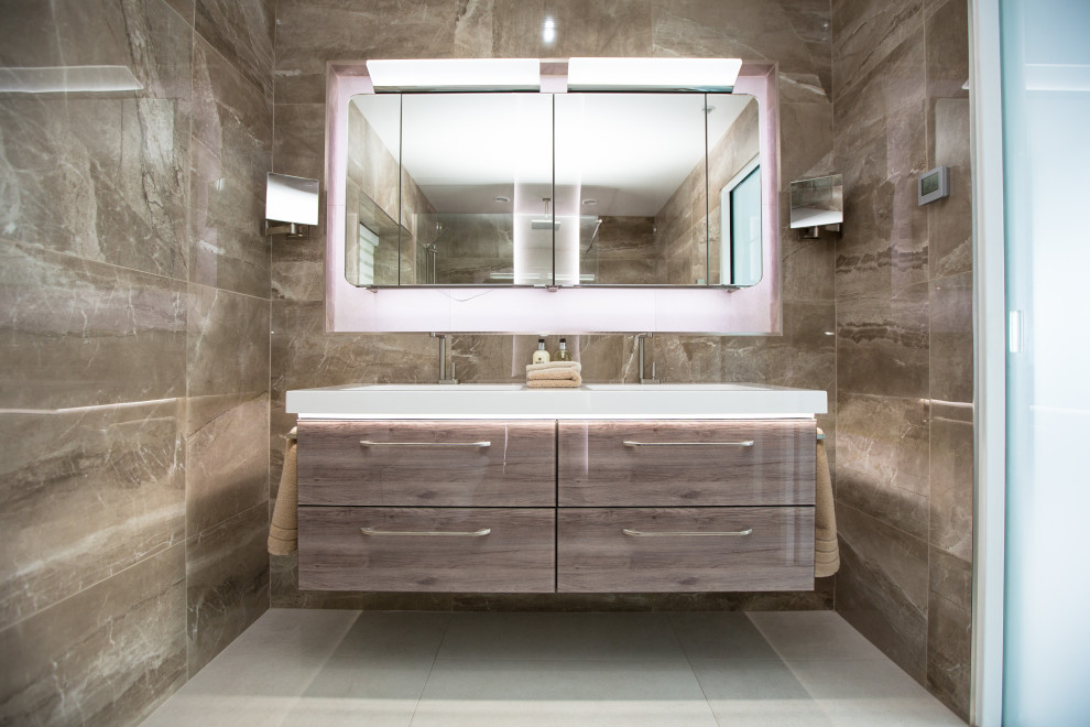 Inspiration pour une grande salle d'eau design en bois brun avec un placard à porte plane, un carrelage gris, un lavabo intégré, un sol gris, un plan de toilette blanc, meuble double vasque et meuble-lavabo suspendu.