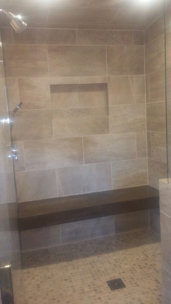 Mid-sized elegant master limestone tile and beige tile limestone floor and beige floor bathroom photo in Los Angeles with raised-panel cabinets, dark wood cabinets, an undermount sink, marble countertops, a hinged shower door and beige walls