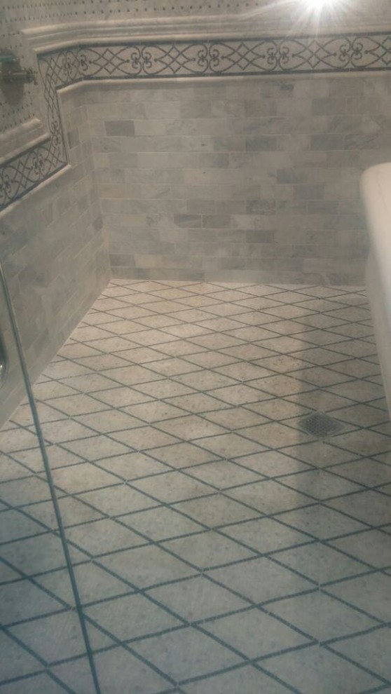 Example of a mid-sized classic master gray tile and limestone tile limestone floor and gray floor bathroom design in Los Angeles with raised-panel cabinets, dark wood cabinets, gray walls, an undermount sink, marble countertops and a hinged shower door