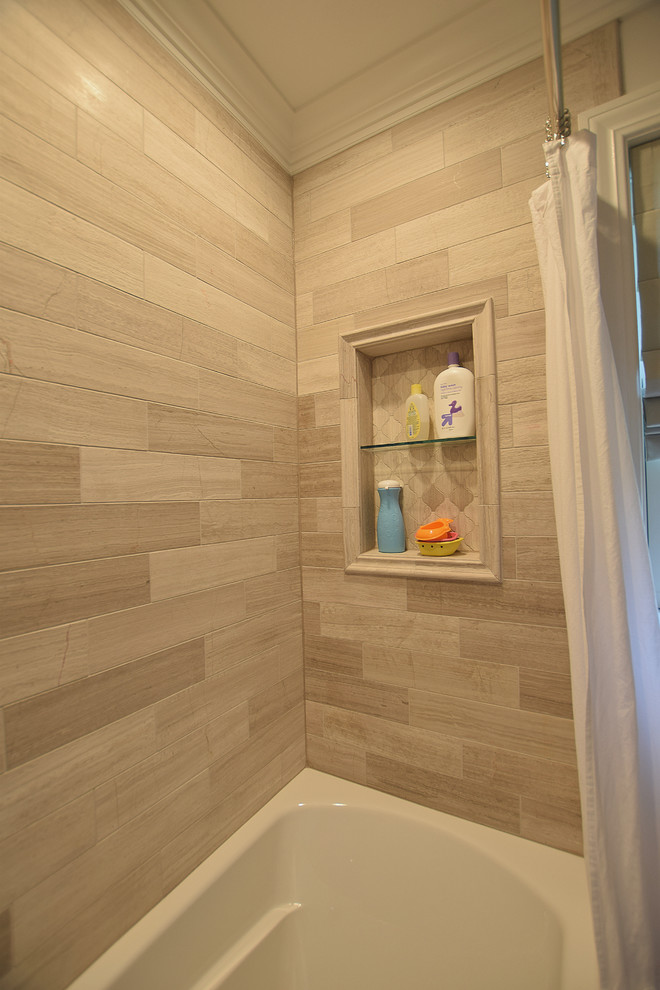 Photo of a small traditional family bathroom in New York with raised-panel cabinets, dark wood cabinets, an alcove bath, a shower/bath combination, a two-piece toilet, grey tiles, limestone tiles, grey walls, limestone flooring, a submerged sink, engineered stone worktops, grey floors and a shower curtain.