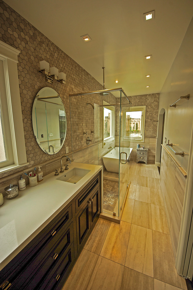 Large contemporary ensuite bathroom in San Francisco with a submerged sink, freestanding cabinets, dark wood cabinets, engineered stone worktops, an alcove bath, a walk-in shower, a two-piece toilet, beige tiles, stone tiles, beige walls and limestone flooring.