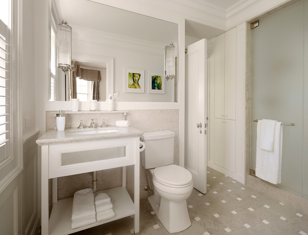 Inspiration for a mid-sized timeless 3/4 gray tile and limestone tile porcelain tile, multicolored floor, single-sink and tray ceiling alcove shower remodel in Chicago with an undermount sink, open cabinets, white cabinets, a two-piece toilet, gray walls, limestone countertops, a hinged shower door, gray countertops and a freestanding vanity