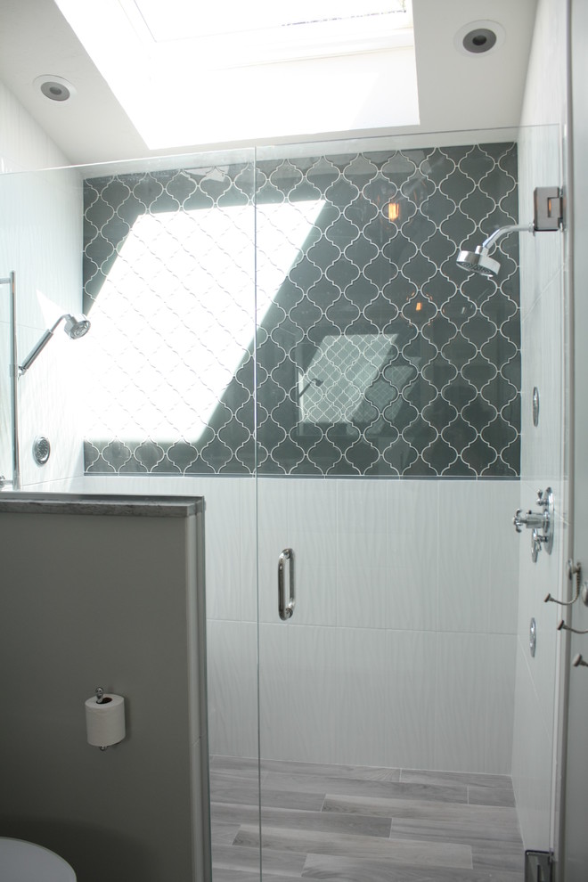Bild på ett vintage en-suite badrum, med ett undermonterad handfat, luckor med infälld panel, vita skåp, bänkskiva i kvartsit, en dubbeldusch, en toalettstol med separat cisternkåpa, grå kakel, keramikplattor, grå väggar och klinkergolv i keramik