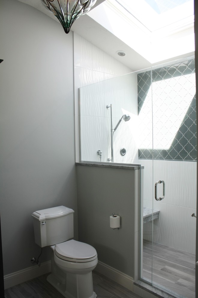Double shower - transitional master gray tile and ceramic tile ceramic tile double shower idea in Boston with an undermount sink, recessed-panel cabinets, white cabinets, quartzite countertops, a two-piece toilet and gray walls
