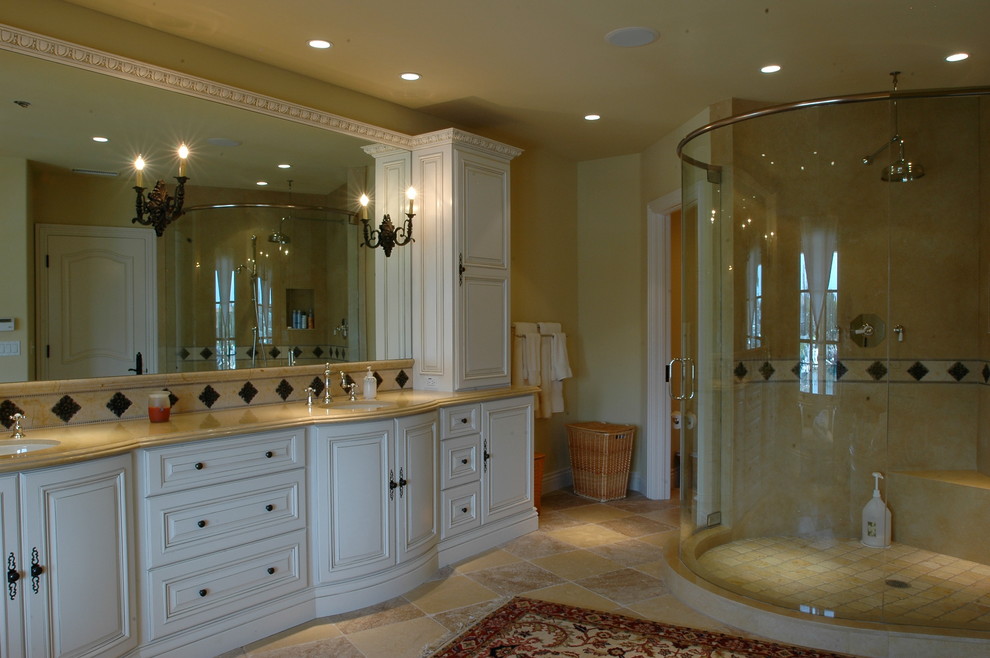 Photo of a large mediterranean ensuite bathroom in Orange County with raised-panel cabinets, white cabinets, a corner shower, beige walls, ceramic flooring, a submerged sink and solid surface worktops.