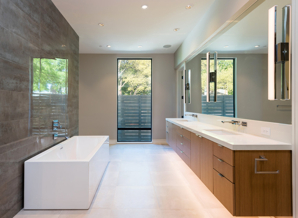 Свежая идея для дизайна: ванная комната в современном стиле с плоскими фасадами, фасадами цвета дерева среднего тона, отдельно стоящей ванной, серой плиткой, бежевыми стенами, врезной раковиной, белым полом и белой столешницей - отличное фото интерьера