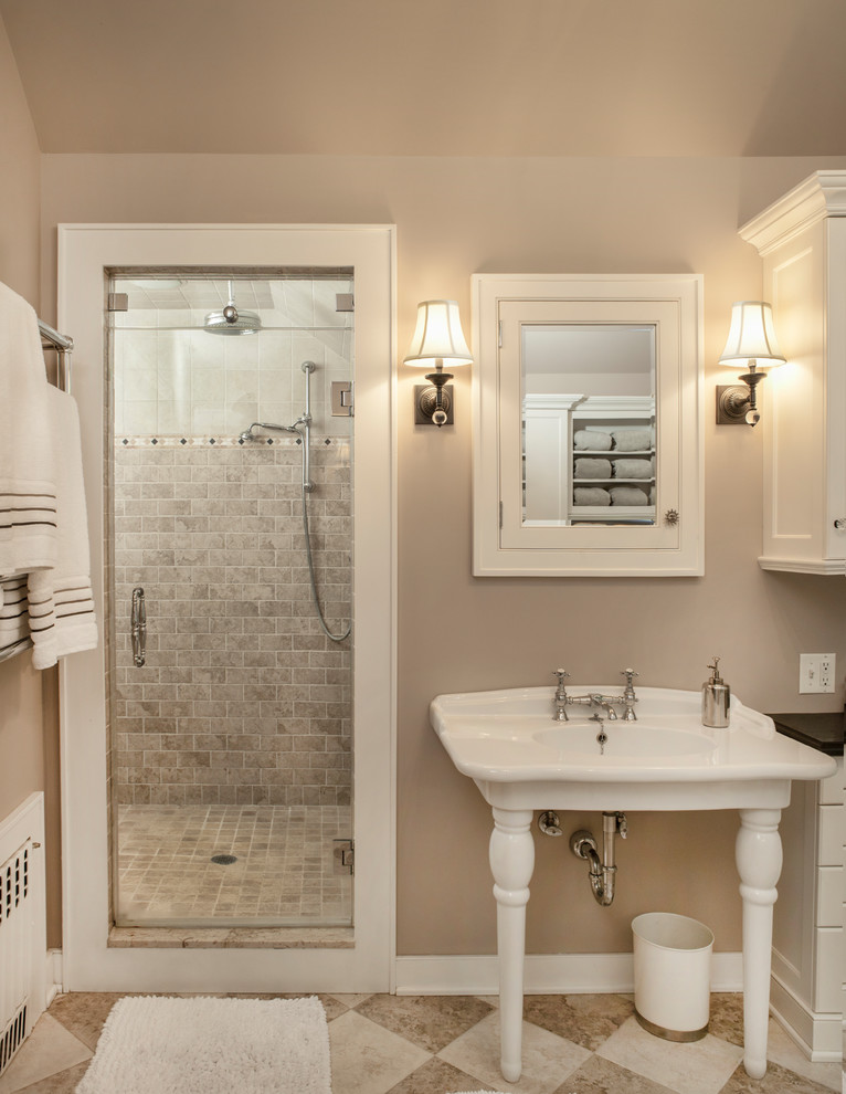 Example of a large classic master beige tile and ceramic tile ceramic tile and multicolored floor bathroom design in New York with flat-panel cabinets, white cabinets, a one-piece toilet, beige walls, a console sink, granite countertops, a hinged shower door and black countertops