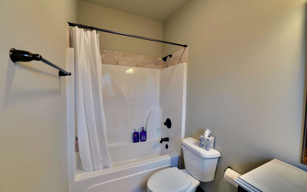 Bathroom - mid-sized craftsman kids' beige tile and travertine tile bathroom idea in Other with furniture-like cabinets, dark wood cabinets, a two-piece toilet, white walls, an undermount sink and granite countertops