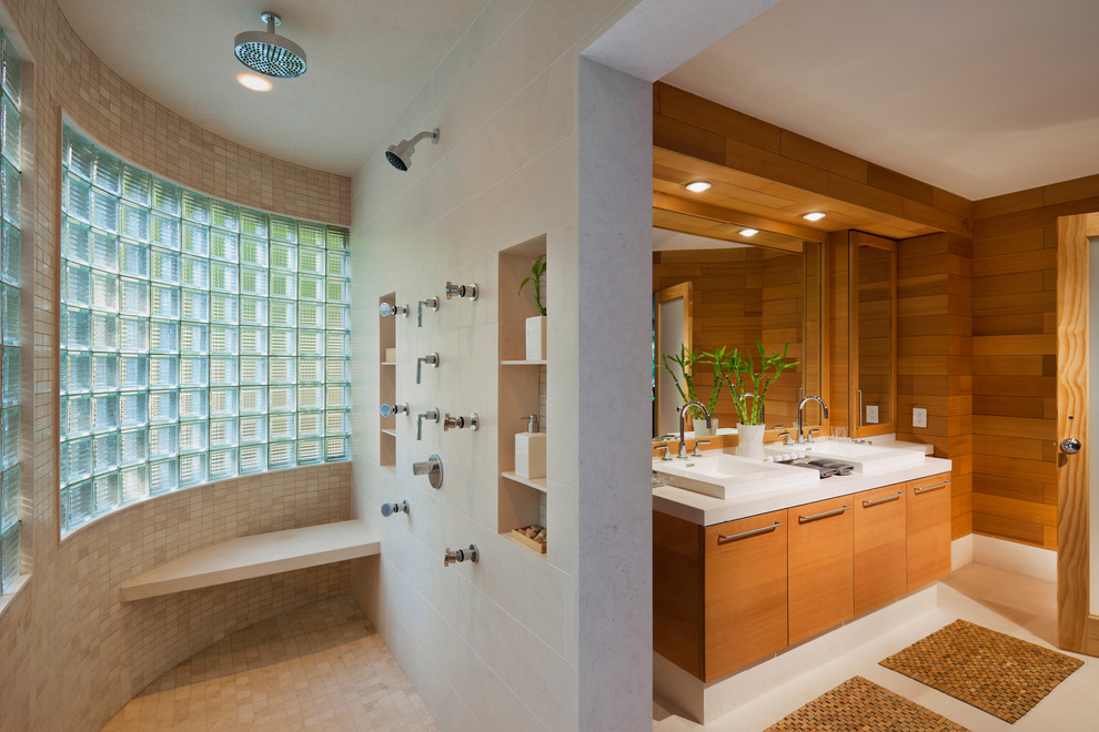 This is an example of a modern bathroom in New York with flat-panel cabinets, medium wood cabinets and a walk-in shower.