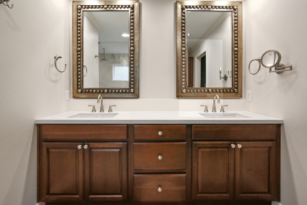 Example of a mid-sized transitional master blue tile and glass tile porcelain tile and beige floor bathroom design in Houston with raised-panel cabinets, dark wood cabinets, a two-piece toilet, beige walls, an undermount sink, quartz countertops and white countertops