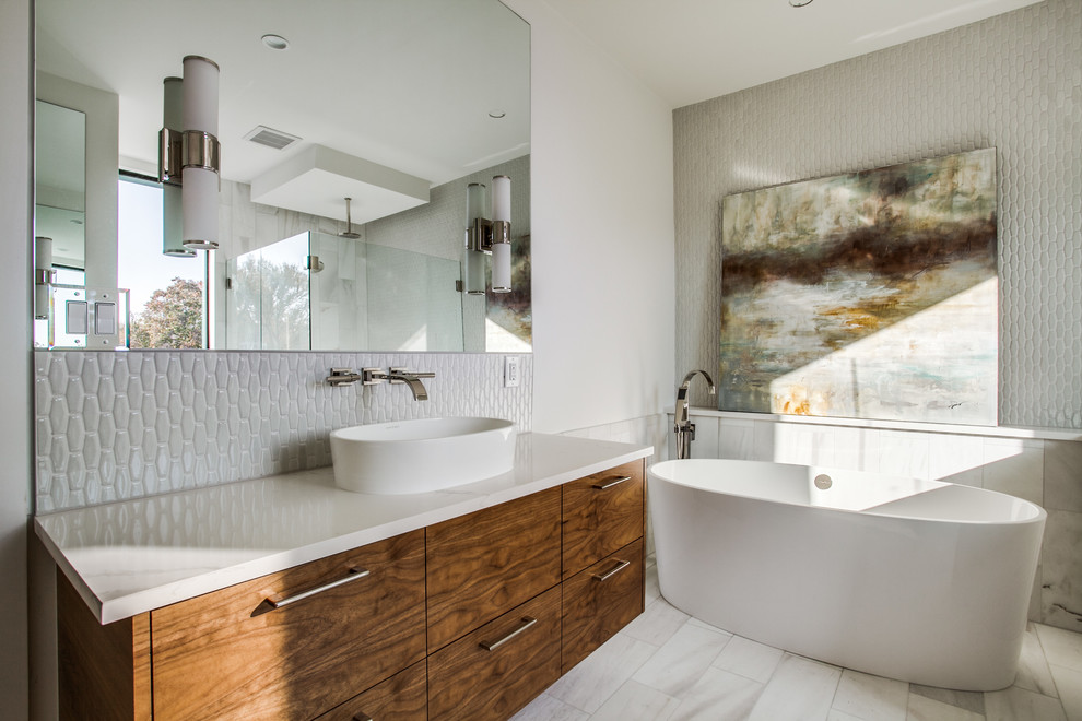Contemporary ensuite bathroom in Dallas with flat-panel cabinets, medium wood cabinets, a freestanding bath, white walls, a vessel sink and white floors.