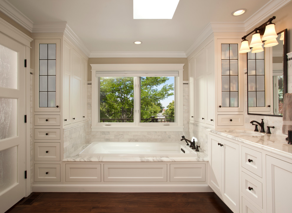 Example of a mid-sized classic master yellow tile dark wood floor alcove bathtub design in Salt Lake City with shaker cabinets, white cabinets, beige walls, an undermount sink and marble countertops
