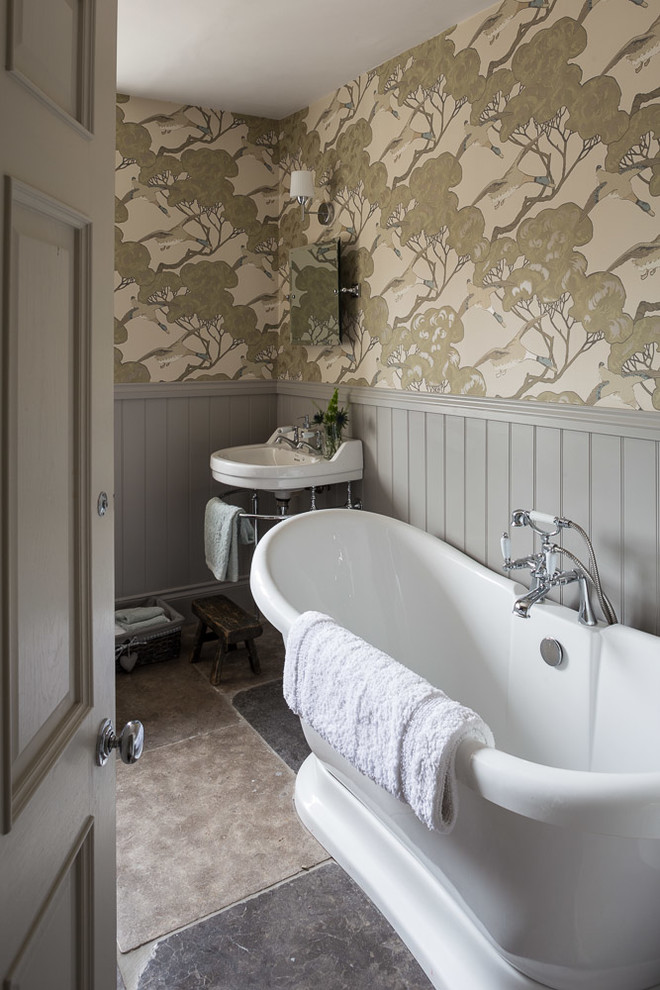 Photo of a classic shower room bathroom in Other with a freestanding bath, beige walls, a console sink and grey floors.