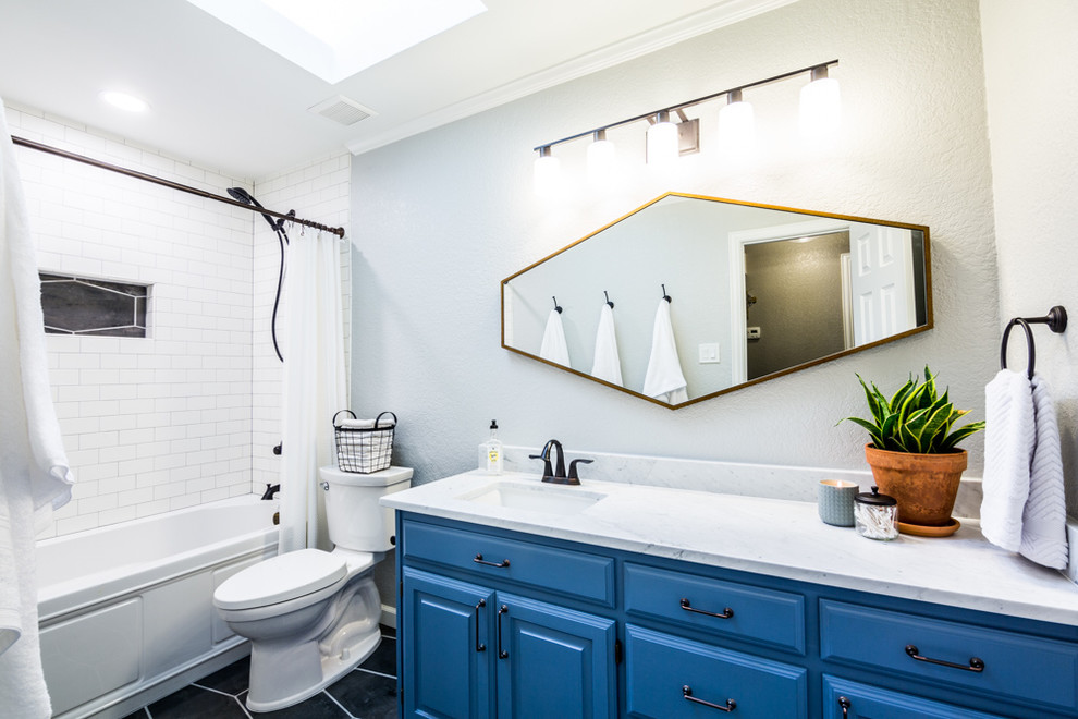 Inspiration for a mid-sized eclectic white tile and subway tile porcelain tile and gray floor bathroom remodel in Dallas with raised-panel cabinets, blue cabinets, gray walls, an undermount sink and marble countertops