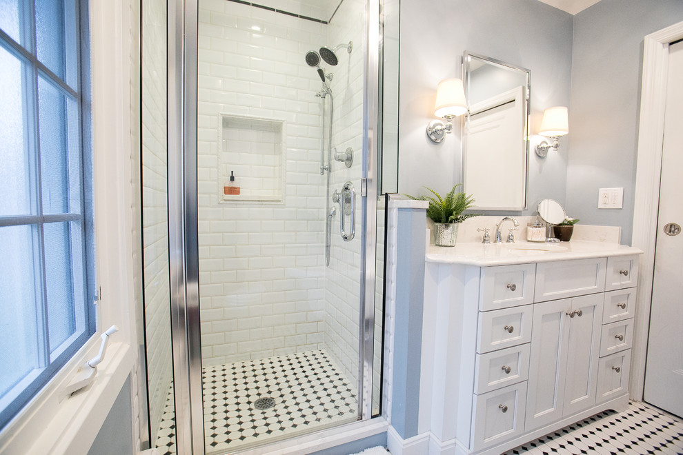 Bathroom - small traditional master white tile and ceramic tile ceramic tile and multicolored floor bathroom idea in Other with furniture-like cabinets, white cabinets, a two-piece toilet, gray walls, an undermount sink, quartz countertops and a hinged shower door