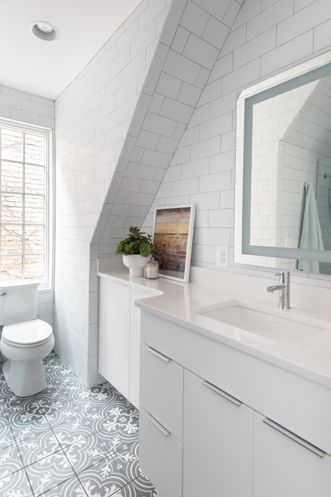Photo of a traditional bathroom in DC Metro with flat-panel cabinets, white cabinets, white tiles, a submerged sink, grey floors, white worktops, a single sink and a floating vanity unit.
