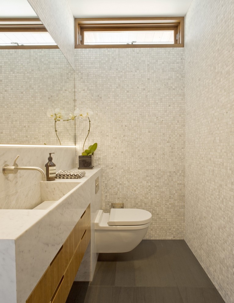 Idéer för ett stort modernt badrum, med skåp i mellenmörkt trä, marmorbänkskiva, en vägghängd toalettstol, grå kakel, mosaik, grå väggar och skiffergolv